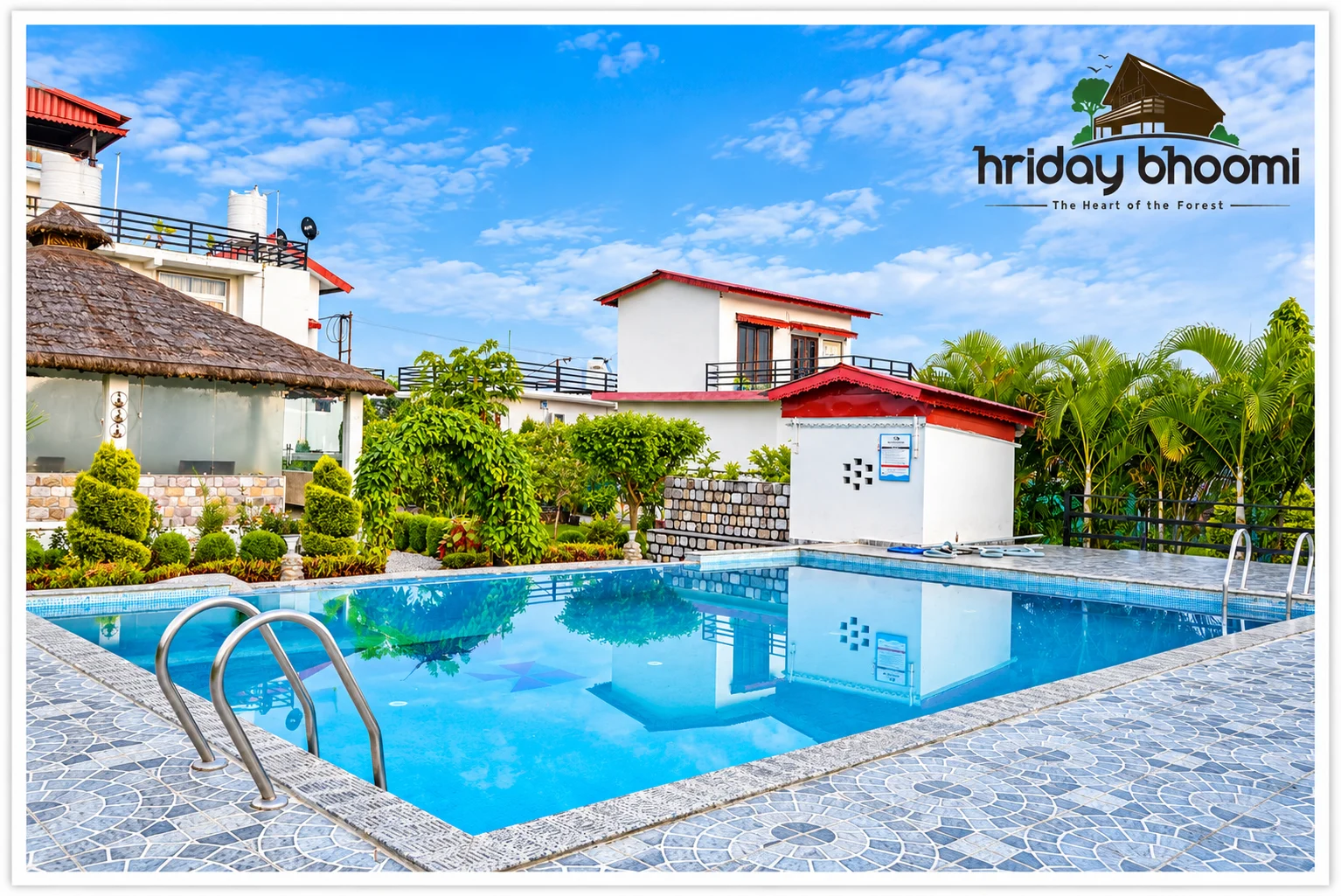 The swimming pool and surrounding buildings at Hriday Bhoomi.