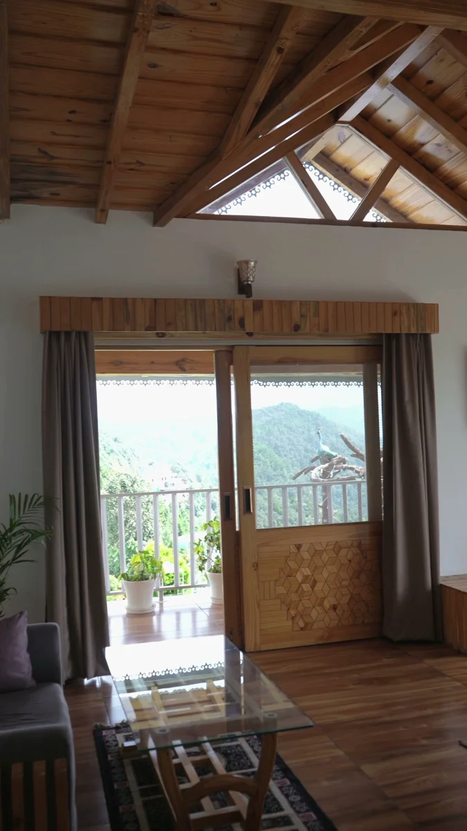 Timber ceiling and seating in a room at The Tahoma; frame from our property film.